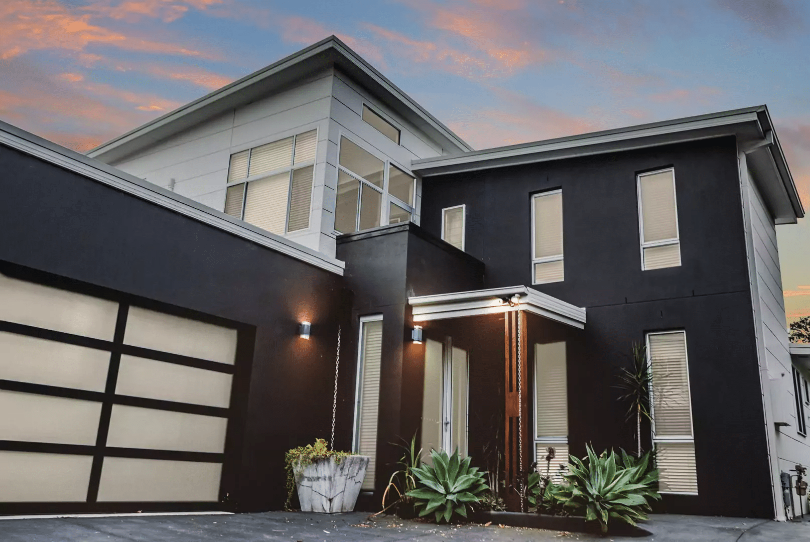 Contemporary black-clad ground floor extension by Adlington Homes