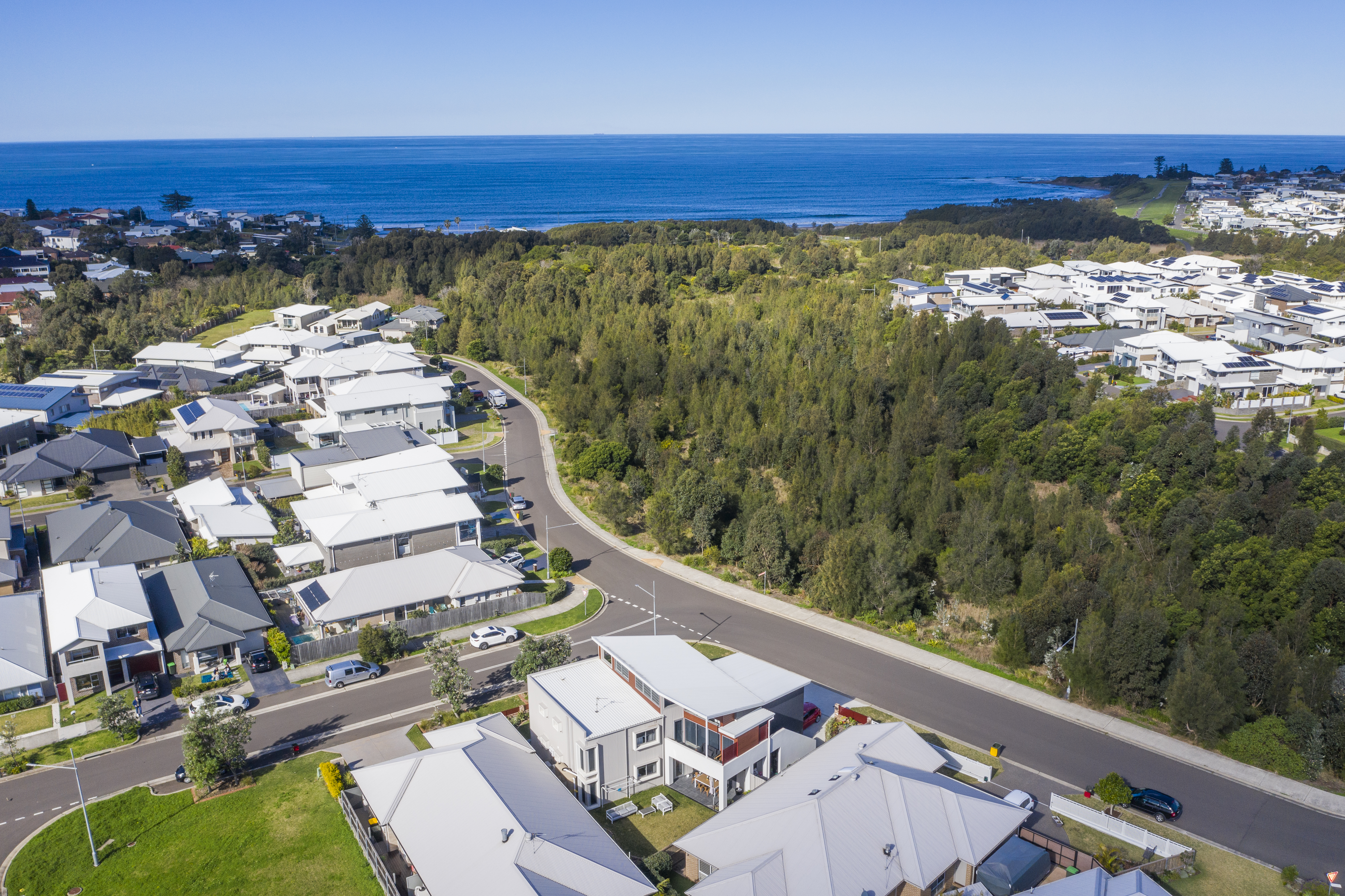 Aerial coastal town view over an Adlington Homes townhouse development